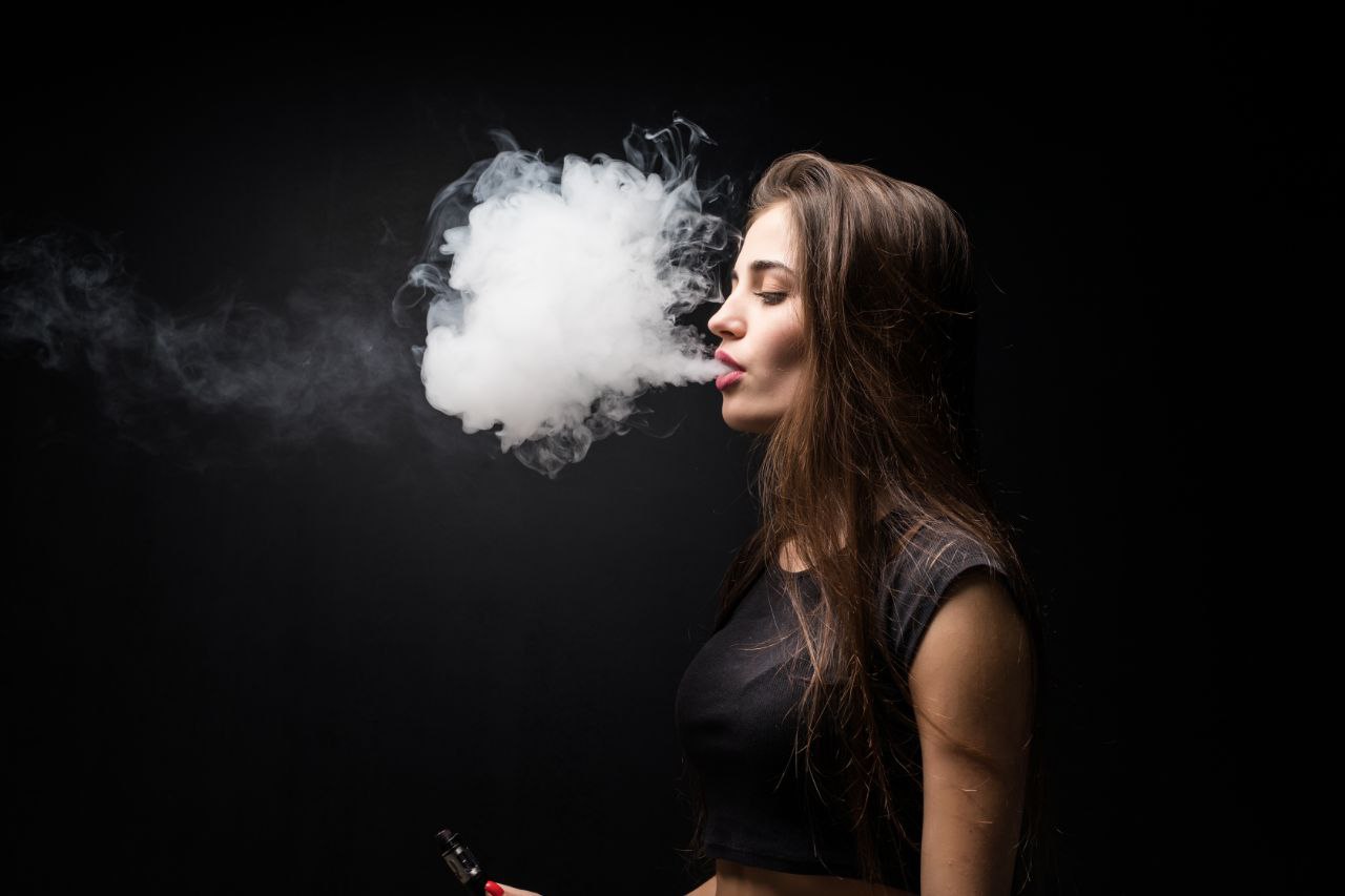 a woman with a cloud of smoke